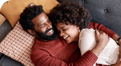 Couple laying on couching laughing