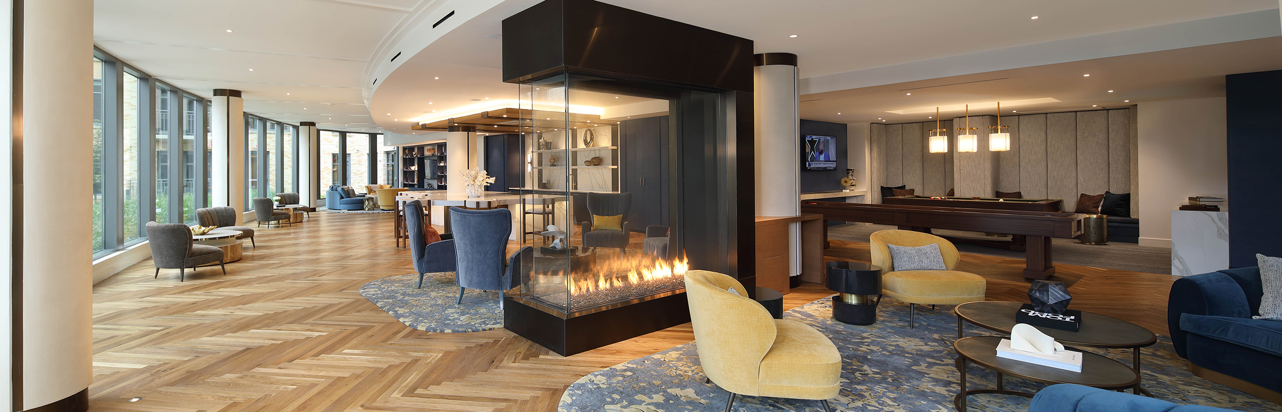 The Milton apartments clubroom image with bar, seating and fireplace