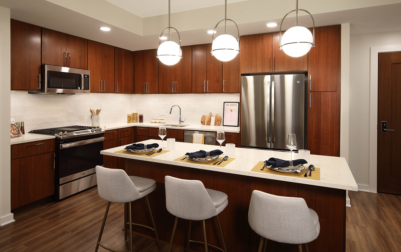 The Milton apartment kitchen with cherry cabinets and large center island