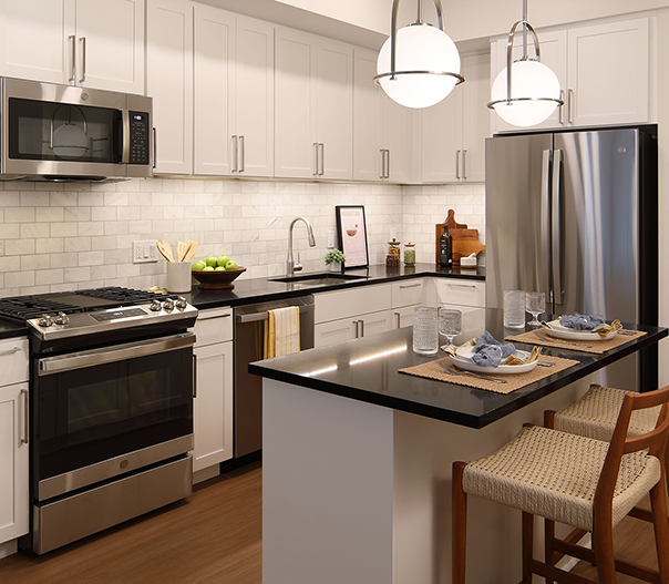 The Milton apartments kitchen with white cabinets and center island