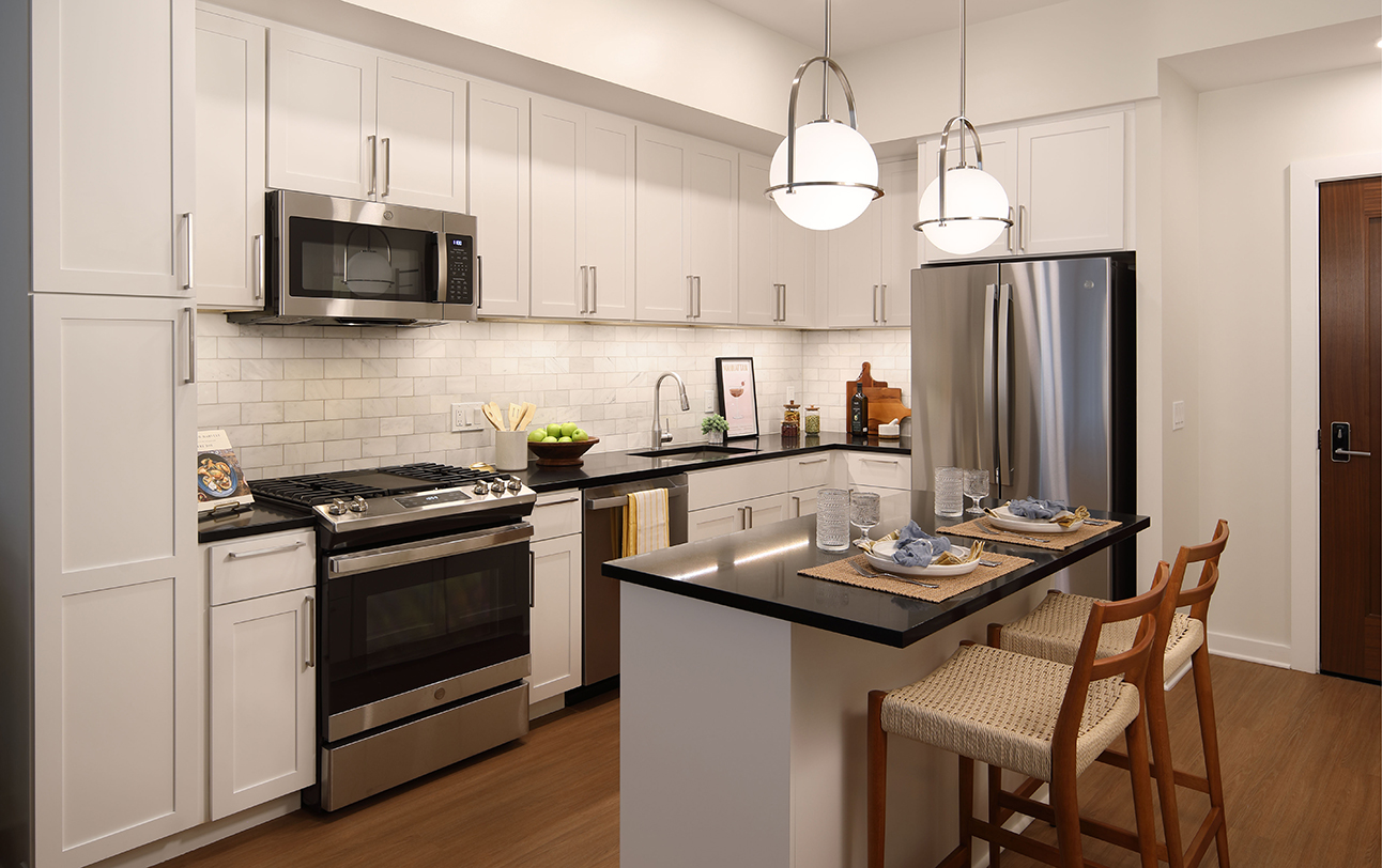The Milton apartments kitchen with white cabinets and center island